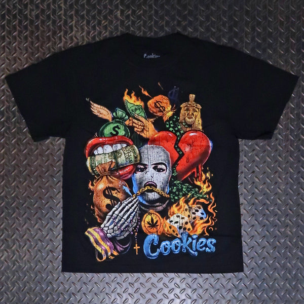 A black short-sleeve graphic t-shirt featuring a colorful collage of religious and monetary symbols, including a skull, money bags, a broken red heart, and the word 'Cookies' in blue text, laid flat on a textured gray diamond plate background. Cookies Collage Premium T-Shirt Black C26TSP15