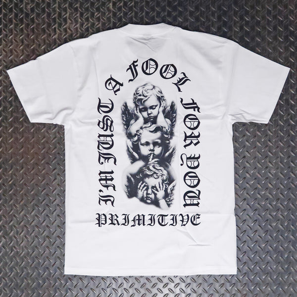 White short-sleeve t-shirt laid flat on a dark diamond plate background, featuring a large black graphic print of cherubs with gothic text reading 'I'M JUST A FOOL FOR YOU'. Primitive Dedication T-Shirt White PAPSP2515
