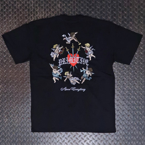 A black short-sleeve t-shirt laid flat on a textured gray diamond plate background, featuring a large graphic print on the back with cherubs, a red heart, a sword, and the text 'Primitive' and 'Above Everything'. Primitive Triumph Heavyweight T-Shirt Black PA425376