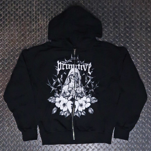 A black zip-up hoodie featuring a large white graphic print on the front with the word 'Primitve' in a gothic font above a hooded figure and floral design, laid flat on a textured gray diamond plate background. Primitive After Zip Hoodie Black PAPSP2628